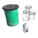 A green painted galvanised bin with rubber cover; a three-tier wirework plant stand; and a
