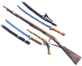 A replica flintlock musket with pine stock and steel barrel; a decorative brass mounted antique