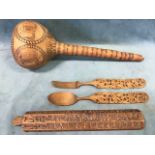 An African carved gourd rattle; a Far Eastern six sided baton carved with pictograms; and a pair