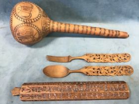 An African carved gourd rattle; a Far Eastern six sided baton carved with pictograms; and a pair