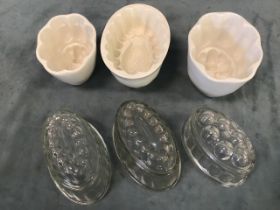 A collection of glass and ceramic jelly moulds, including Victorian Copeland , pressed glass,