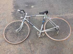 A Raleigh Jubilee touring bicycle, with soft seat, drop handlebars, 10-speed derailleur gears, etc.