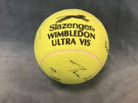 A giant autographed tennis ball, bearing the signatures of Andre Agassi, Tim Henman, Serena