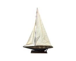 A wood model of a J-Class racing yacht by Hanan, with cotton sails, brass decking mounts, etc.,