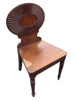 A C19th mahogany hall chair with oval ribbed back above a waisted panel, with flared rectangular