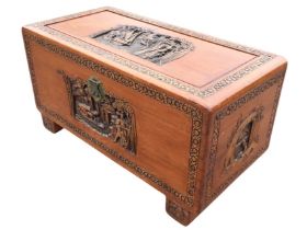 A carved camphorwood chest, the rectangular top with figures and boats within a floral border,