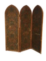 A Victorian three-panel folding screen, the gothic arched wood frames with toile backed damask