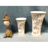 A handpainted European porcelain vase decorated with landscape scene on ruby ground with gilding,