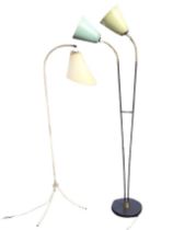 A mid-century tubular steel and brass floor lamp, the curved stem above a brass disc collar, on