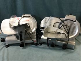 An Italian stainless steel electric ham slicer with adjustable ribbed plates on rectangular stand;