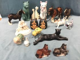 A quantity of ceramic animals including Beswick cart horses, two cow creamers, cats, foals, a studio