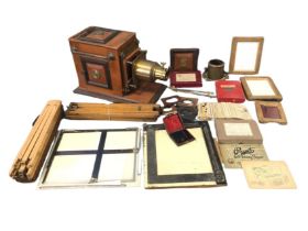 A mahogany cased magic lantern with brass mounts on moulded plinth; and a box of miscellaneous