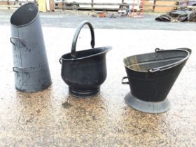 Two painted helmet shaped coal scuttles with rolled rims & swing handles; and a tapering ribbed coal
