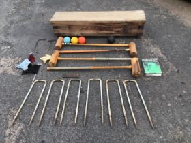 A boxed Harrods lawn croquet set with mallets, balls, hoops, pegs and a 1966 first edition of