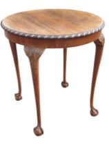 An Edwardian mahogany occasional table, the circular gadrooned top above a plain frieze, raised on