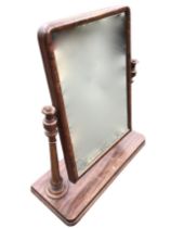 A Victorian mahogany dressing table mirror, the rectangular plate suported by turned tapering