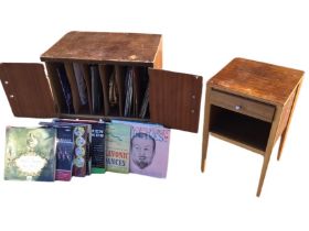 A walnut record cabinet containing a quantity of vinyl LPs - musicals, classical, some 78s, etc.,