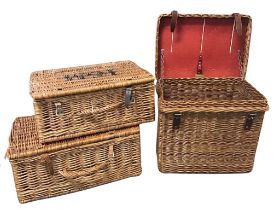 A rectangular Fortnum & Masons cane picnic hamper with leather straps; another similar unmarked; and