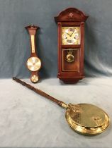 An Infinity Vienna style mahogany chiming wall clock, the shaped cornice above a brass dial with