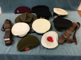 A collection of uniform headwear - Royal Navy officers, petty officers and ratings caps, two