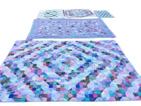 Five contemporary colourful patchwork quilts - three of cot size. (5)