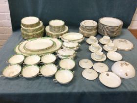 A Staffordshire Crescent dinner service with green & gilt scrolled borders - dessert, soup, side,