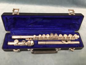 A cased Rosselli nickel plated flute.