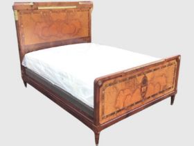 C20th French brass-mounted mahogany bed, the headboard with foliate cornice above a burr panel