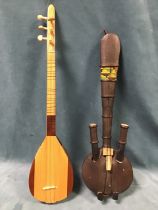 A gourd shaped string instrument with six strings and pegs, having inlaid decoration; and another