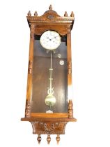 A large Vienna wallclock with seven turned finials to cornice above dentil mouldings, the