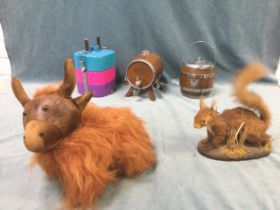 A taxidermied red squirrel; a leather highland cow doorstop; a tiffin box; an oak biscuit barrel