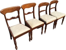 A pair of Victorian mahogany dining chairs, the shaped backs above scrolled carved rails, the drop-