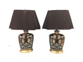 A pair of contemporary lacquered ceramic tablelamps, with foliated scrolled decoration on black