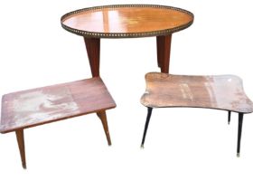 An oval mahogany coffee table, the top with pierced brass gallery raised on square tapering legs;