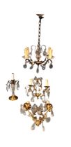A brass chandelier with four scrolled branches supporting candlelights and crystal drops; a matching