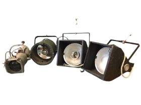 A pair of theatrical floodlights with brackets and safety chains; a Strand Electric spotlight with