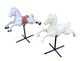 Two Triang pressed metal rocking horses, one with original paintwork, in galloping pose with moulded