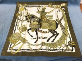 A silk Le Timbalier design Hermès scarf, the drummer mounted on horseback on white ground with green