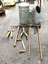 A galvanised dustbin and cover of ribbed form; miscellaneous old garden tools including a pickaxe, a