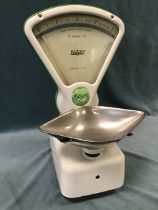 A set of 1950s Avery enamelled cast iron shop scales with nickel plated weighing pan and fan