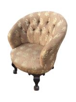 A late Victorian button upholstered tub armchair with rounded back above a studded sprung seat,