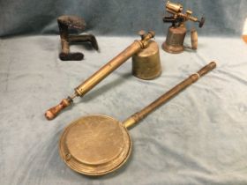 A 1910 copper mounted blowlamp; a cast iron shoe last; a brass bedwarming pan with engraved stag