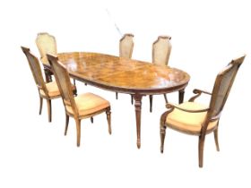 A Drexel Heritage extending walnut dining table, the crossbanded parquetry top above a moulded apron