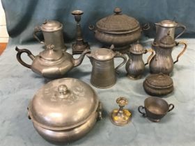 A collection of pewter - a three-piece rococo style coffee set, a similar covered soup tureen, a