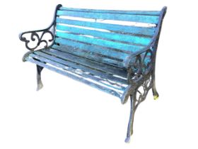 A rectangular 4ft garden bench with slatted back & seat on scrolled cast iron supports with
