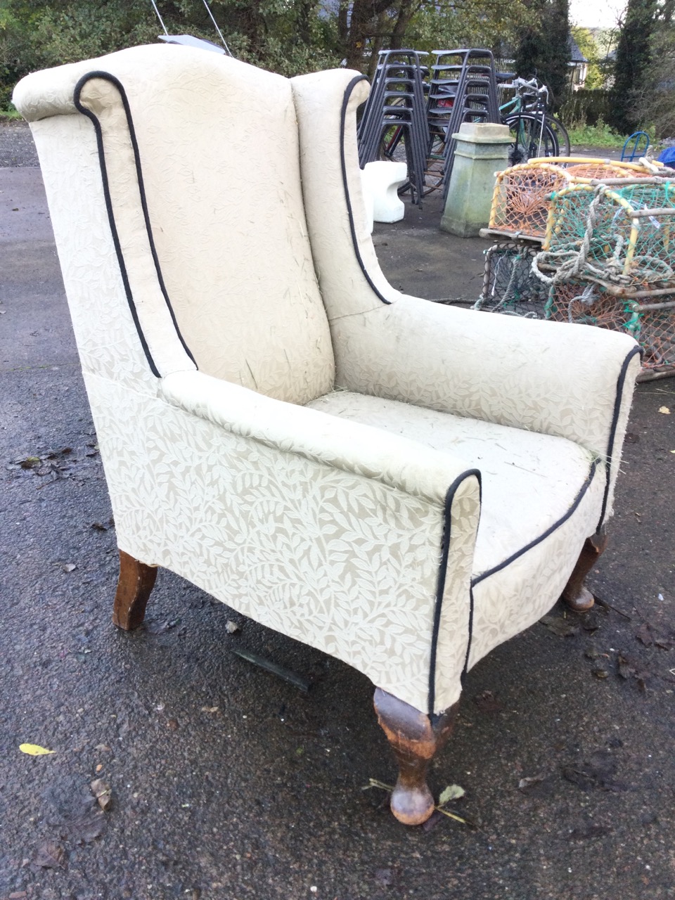An Edwardian upholstered wing armchair, the arched back and outscrolled wings above a bowfronted - Image 3 of 3