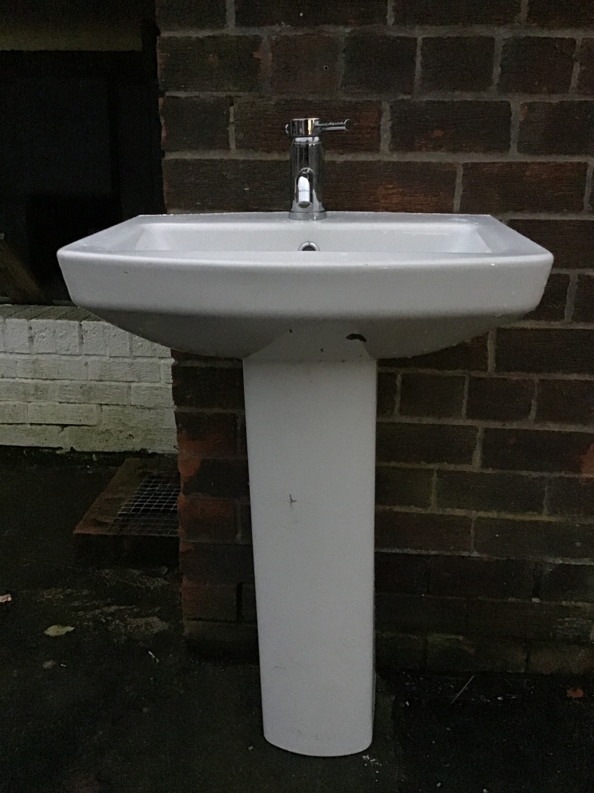 A contemporary ceramic pedestal washbasin with central chromed mixer tap and fittings. (22in x - Image 3 of 3
