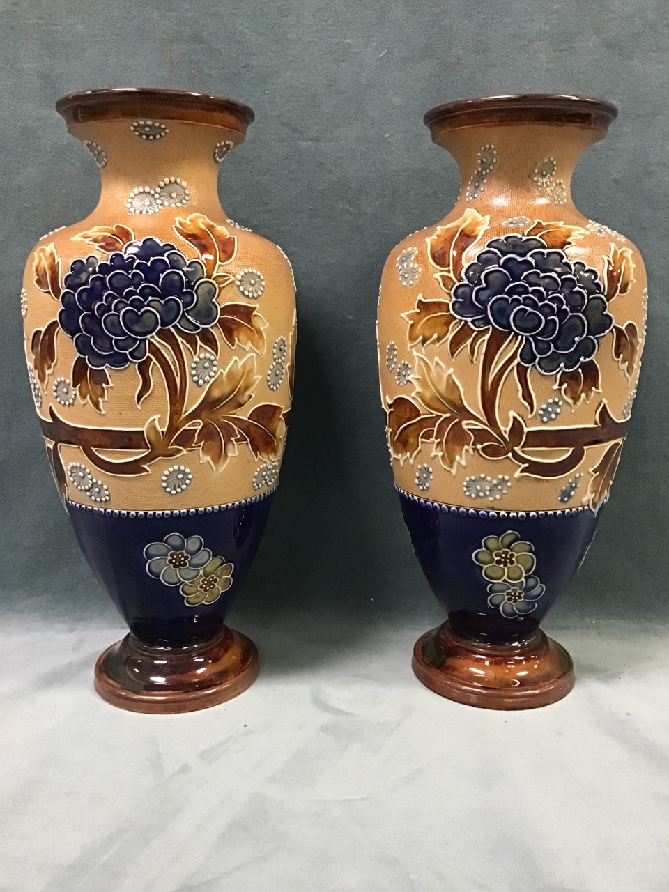 A pair of Doulton Lambeth stoneware vases, with tubelined decoration of peonies and flowerheads by
