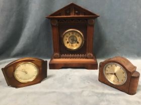 An Edwardian walnut mantel clock, the architectural case with pedimented top above a carved