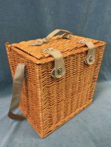 An unused cane picnic hamper with shoulder strap and leather style handle, the fitted interior